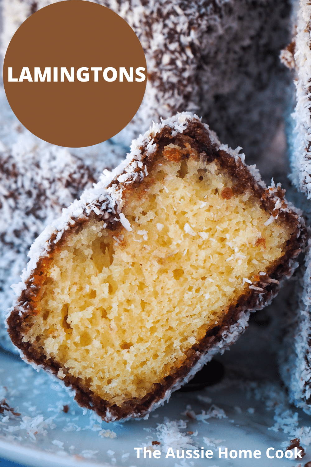 Lamingtons 41 Close up of cut open lamington with other lamingtons piled around it, and text overlay, Lamingtons, the Aussie home cook.