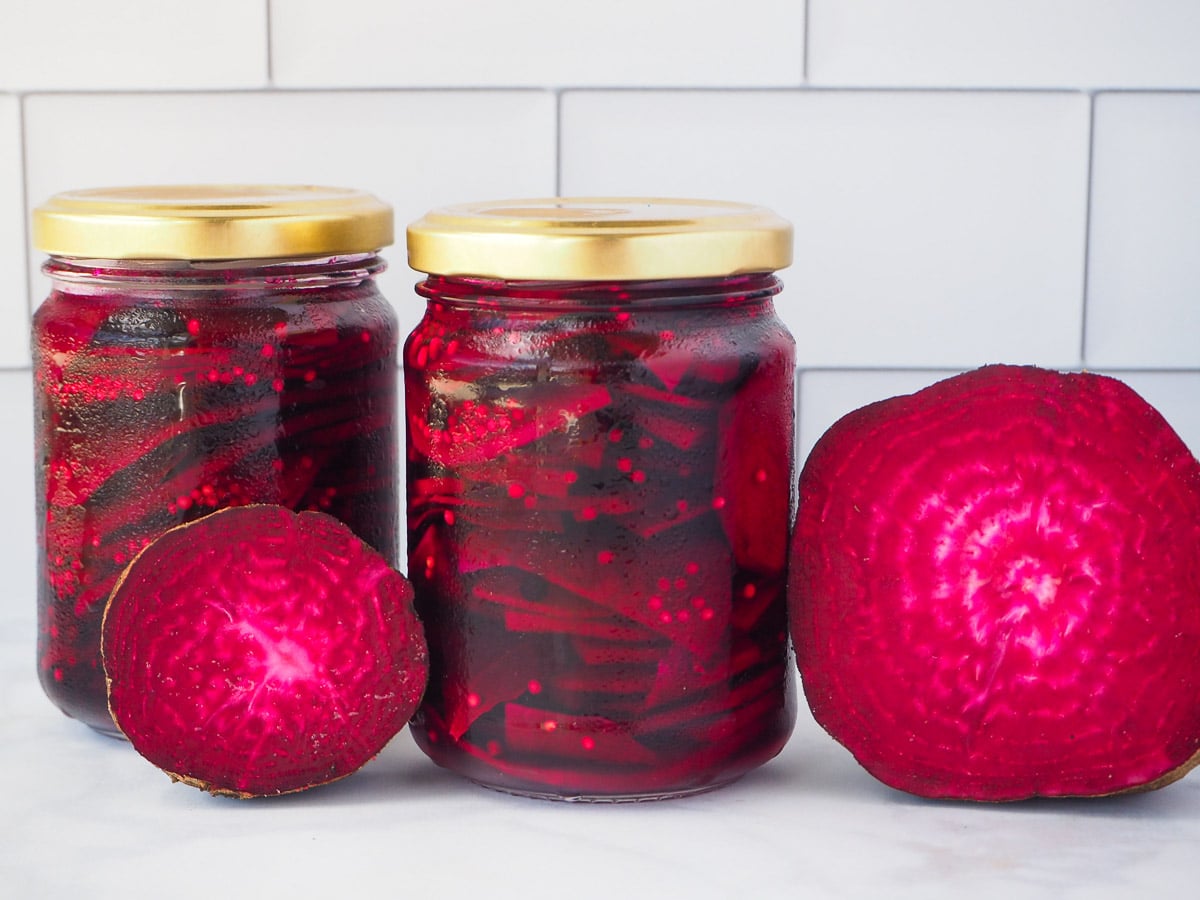 Refrigerator pickled beets 15 Two jars of refrigerator pickled beets with fresh beets on the side.