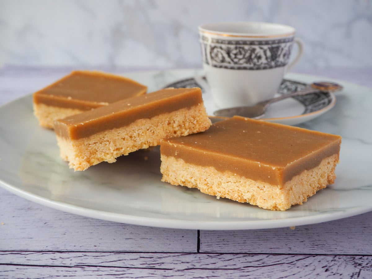 Ginger crunch 21 Pieces of ginger crunch with a coffee cup and spoon.