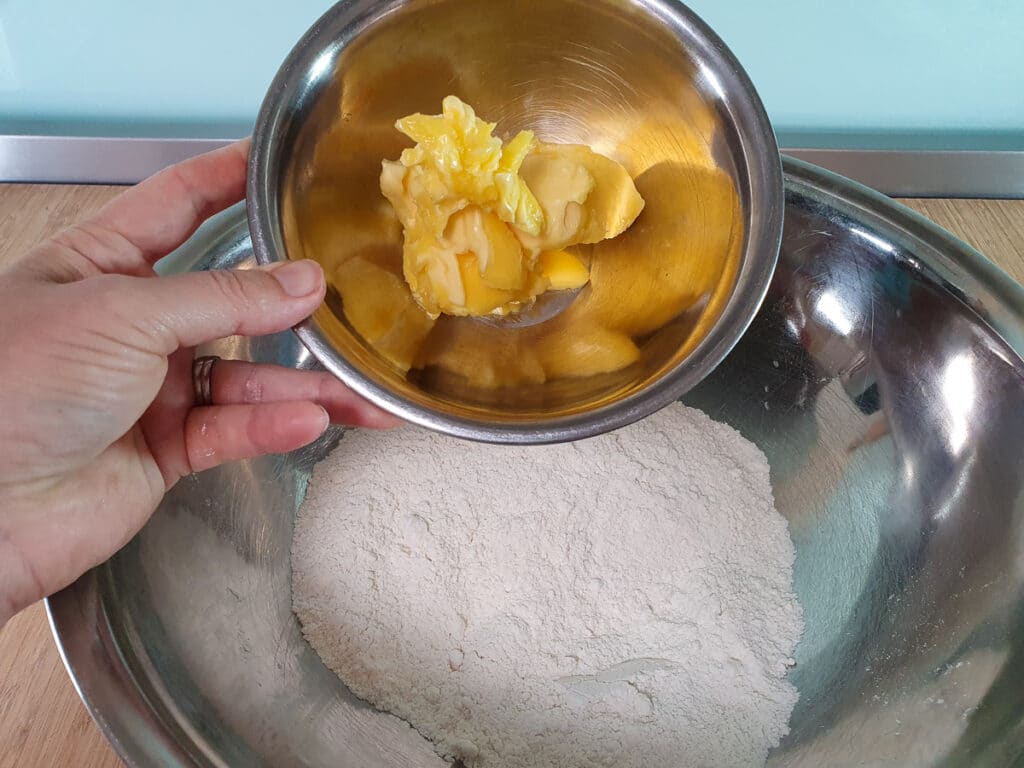 Ginger crunch 10 Adding butter to bowl.