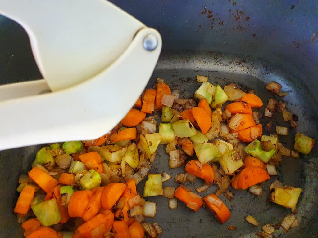 Slow cooker lamb ragu 21 Adding crushed garlic to vegies.