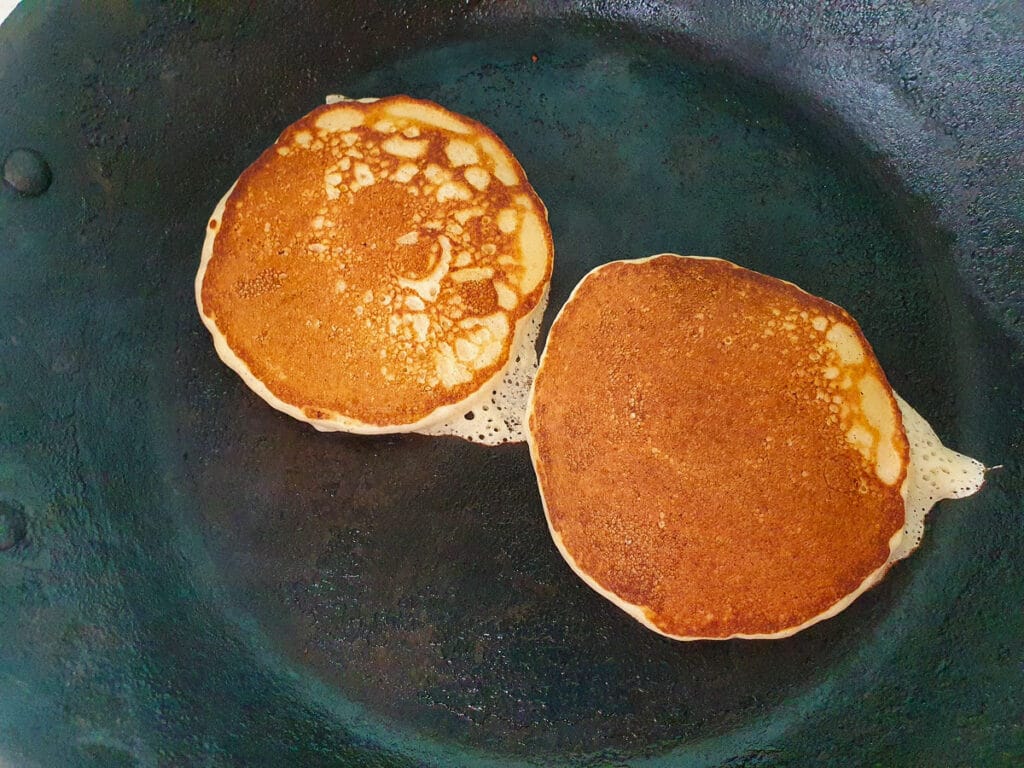 Banana pikelets 13 Flipped banana pikelets cooking on the other side.