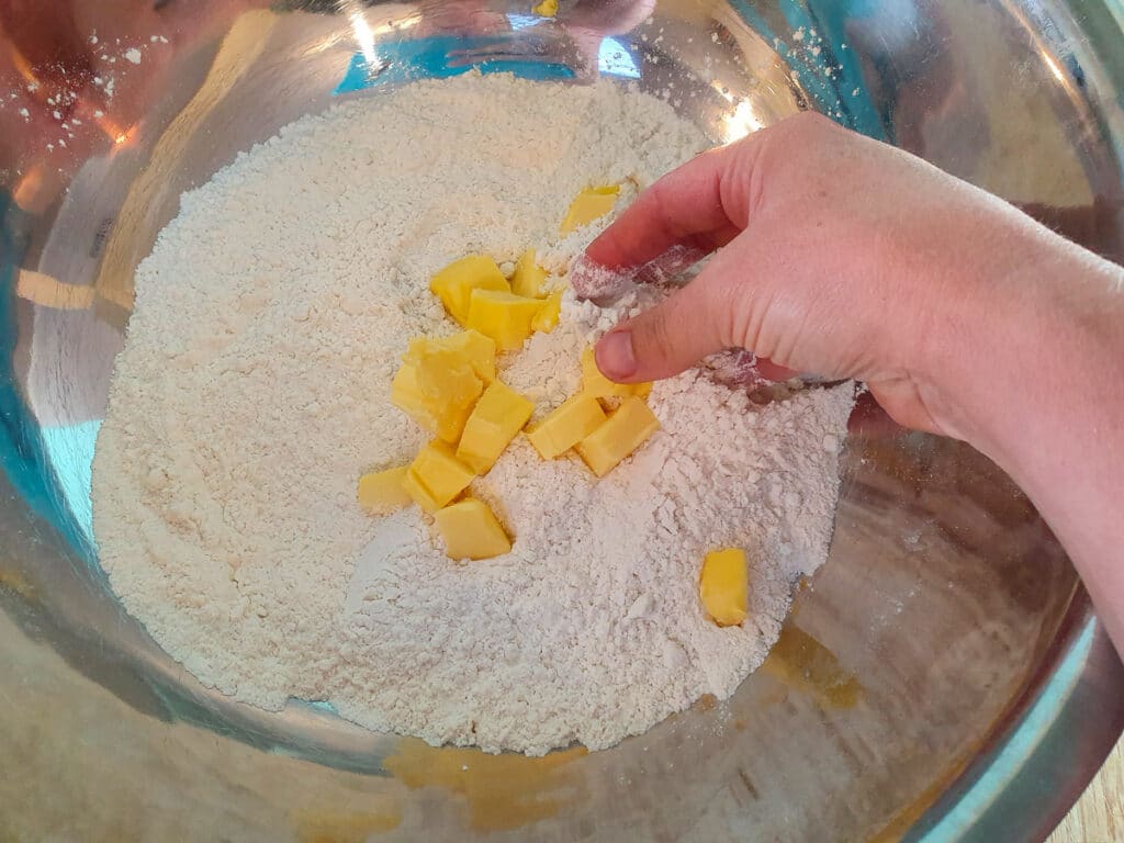Damper 5 Rubbing butter into the flour.