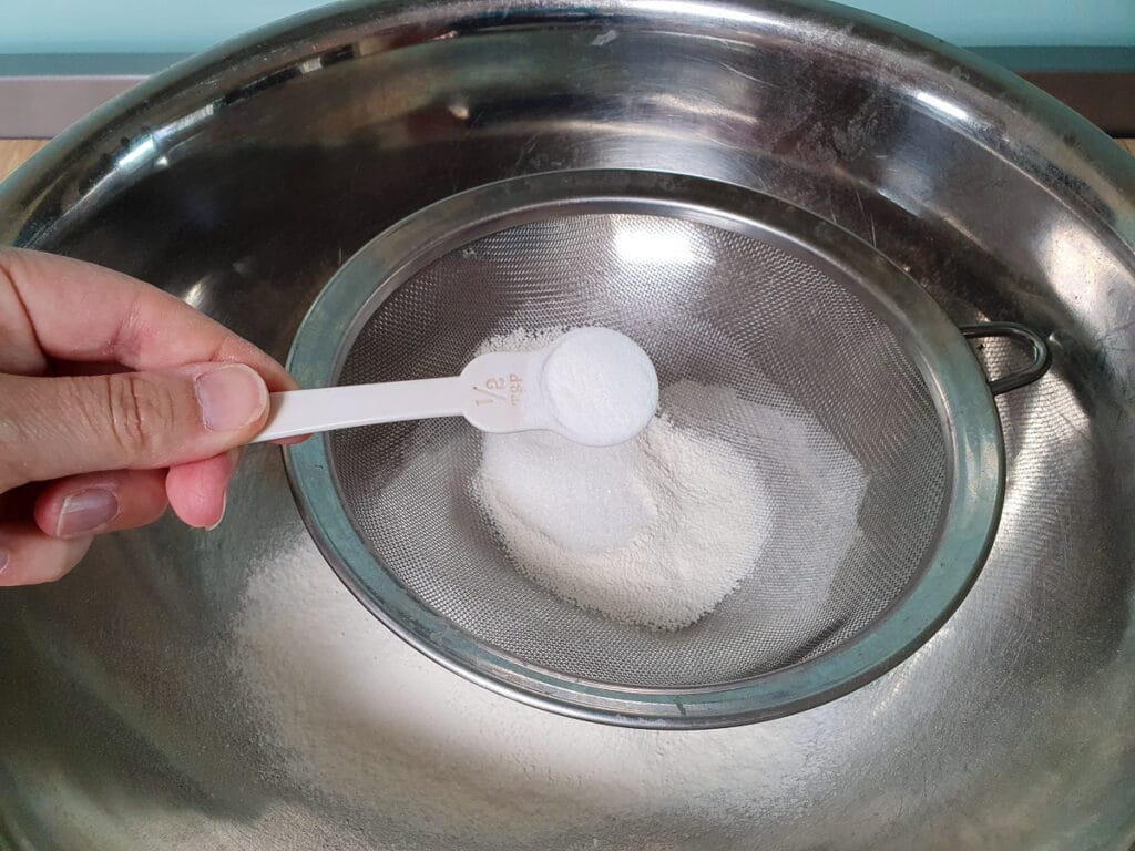 Pikelets 6 Adding baking powder to dry ingredients.