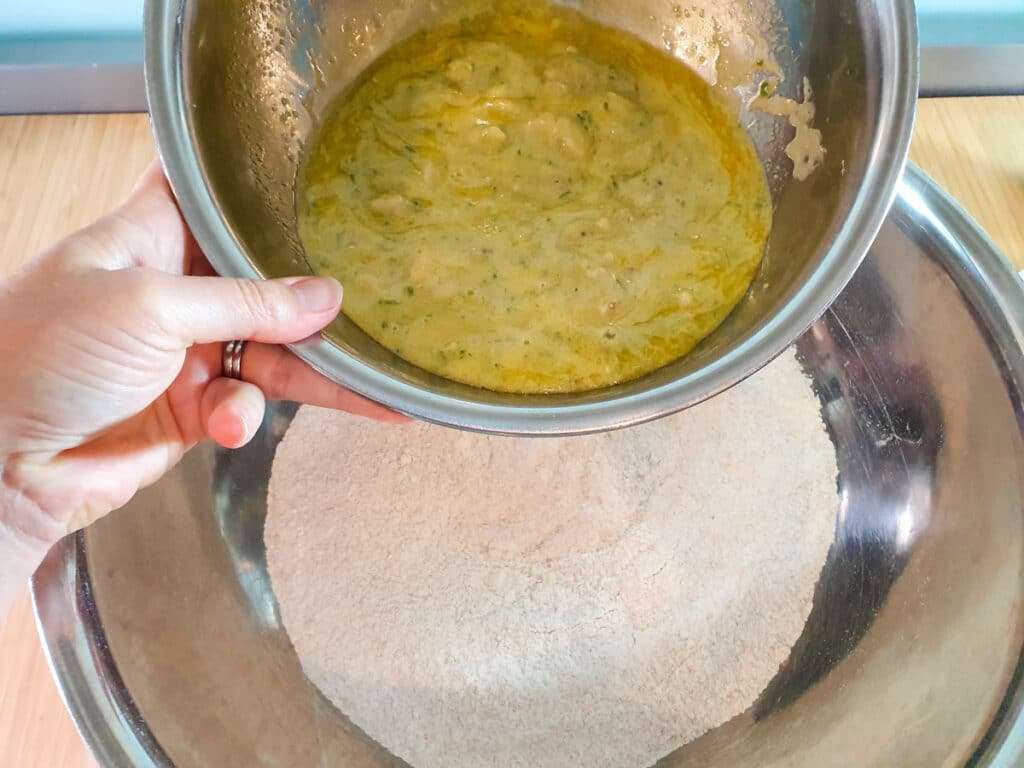 Feijoa muffins 12 Adding wet ingredients to dry ingredients.