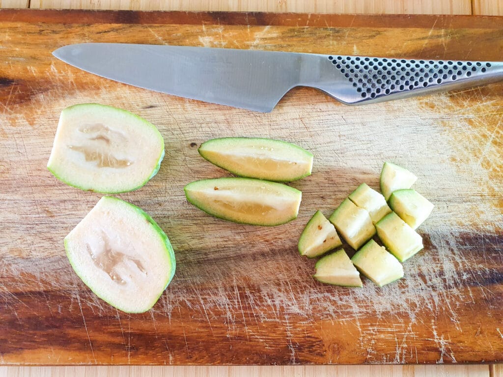 Feijoa chutney 4 Slicing whole feijoas into bite sized pieces.