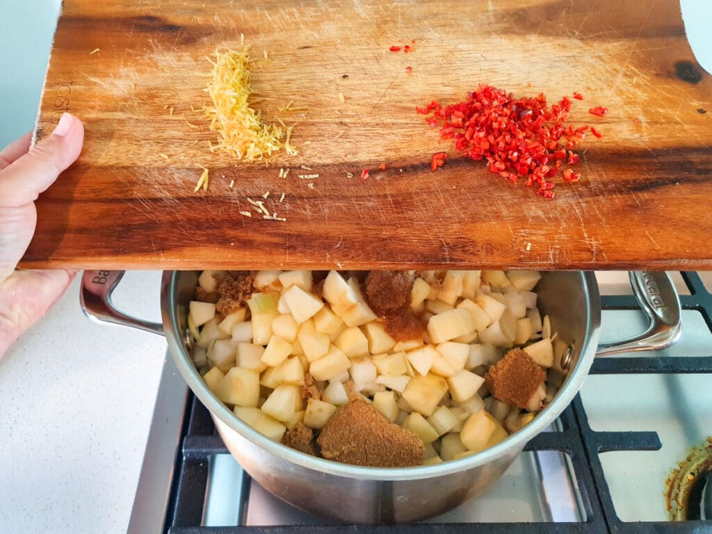 Feijoa chutney 11 Adding lemon zest and chilli to pot.