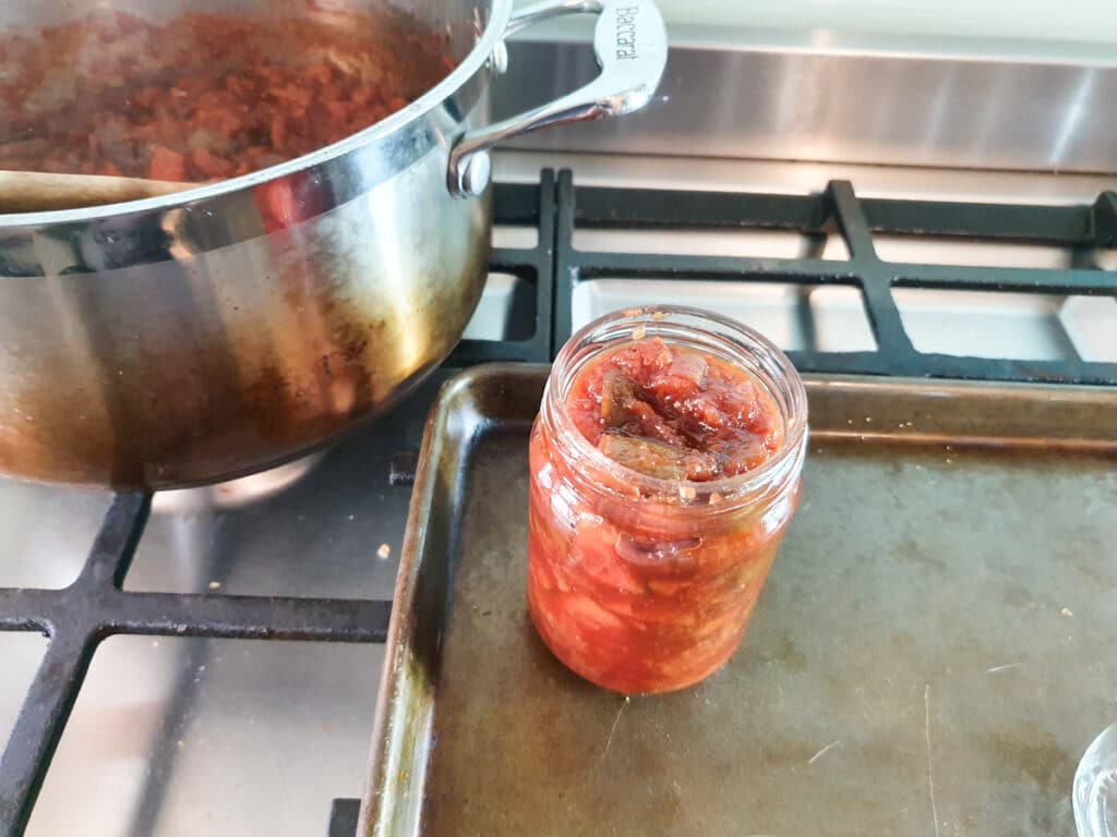 Feijoa chutney 14 Putting chutney into sterilized jars.