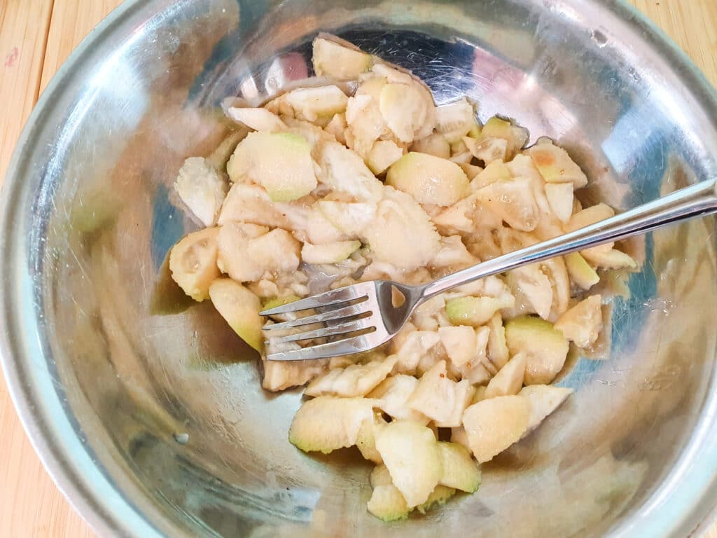 Feijoa loaf 9 Lightly mashing feijoa flesh with a fork.