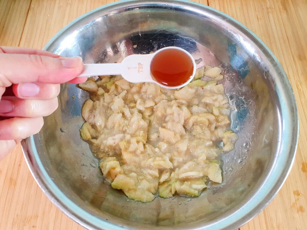 Feijoa loaf 10 Adding vanilla to mashed feijoas.