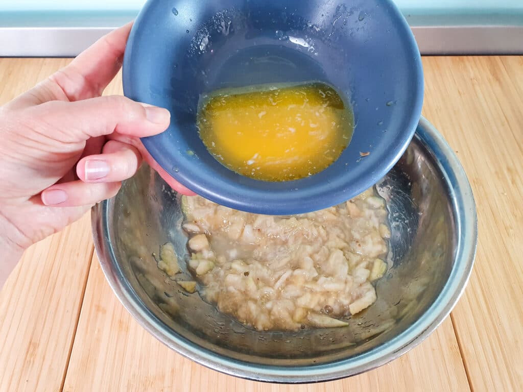Feijoa loaf 11 Adding melted butter to mashed feijoas.