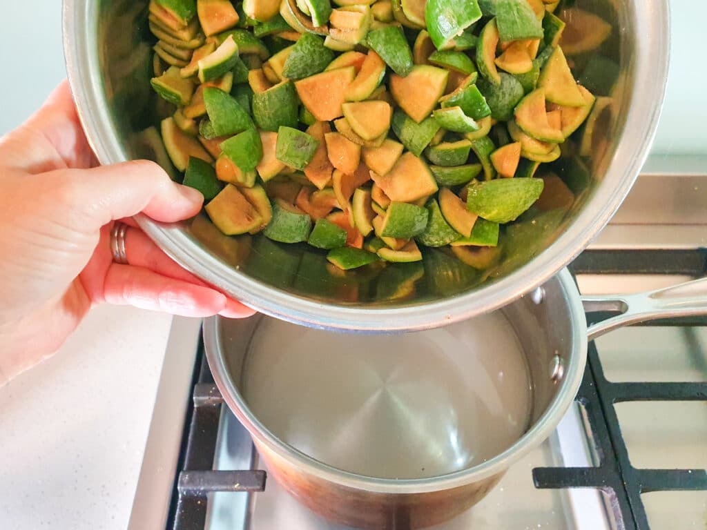 Feijoa syrup 6 Adding chopped feijoa skins to pot.