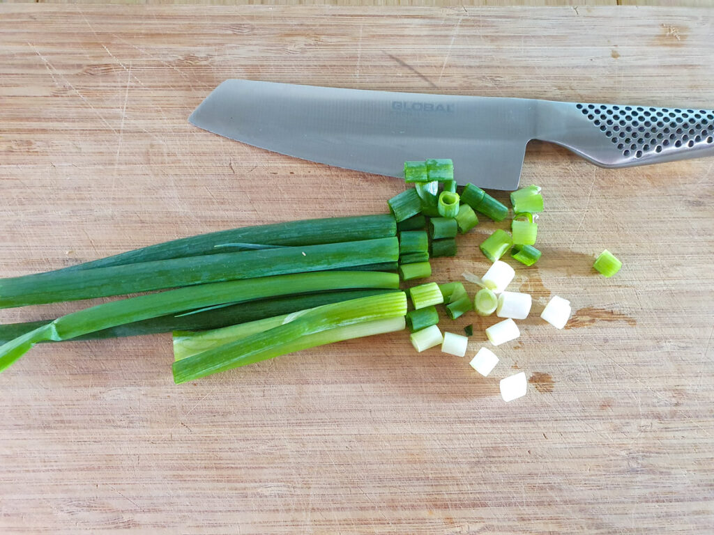 Chilli Chicken Gravy 4 Cutting up spring onions.