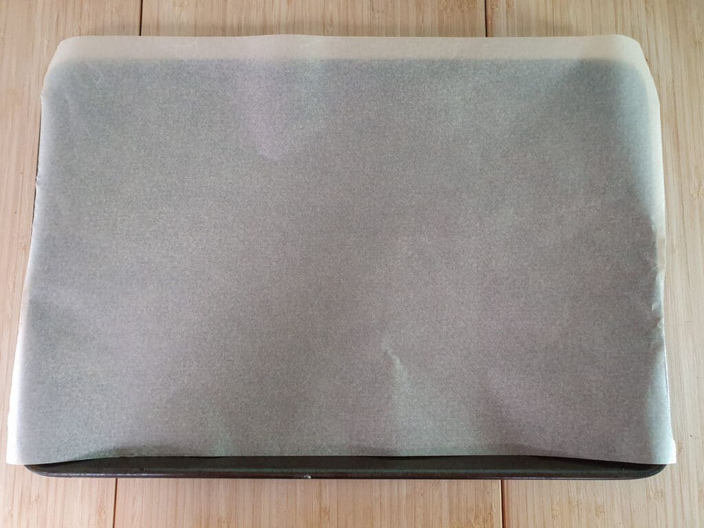 Cheesymite Scrolls 4 Lining a tray with baking paper.