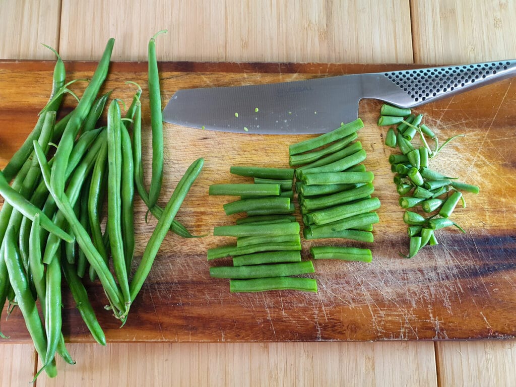Four Bean Salad 4 Slicing off top and tail of green beans and slicing in half.