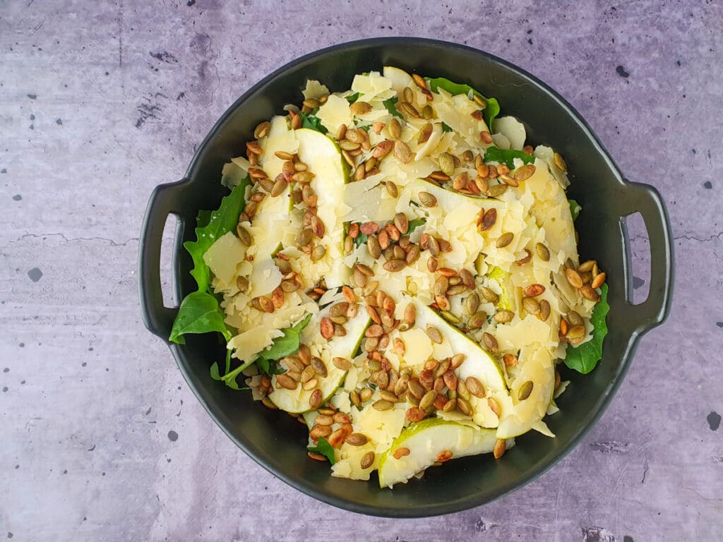 Rocket and Pear Salad 10 Building salad, adding toasted pepitas.