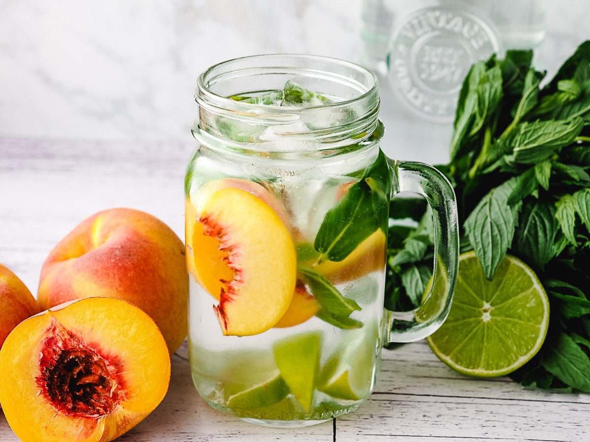 Peach Water 8 Peach infused water with lime and mint, with fresh peaches, lime and mint on the side.