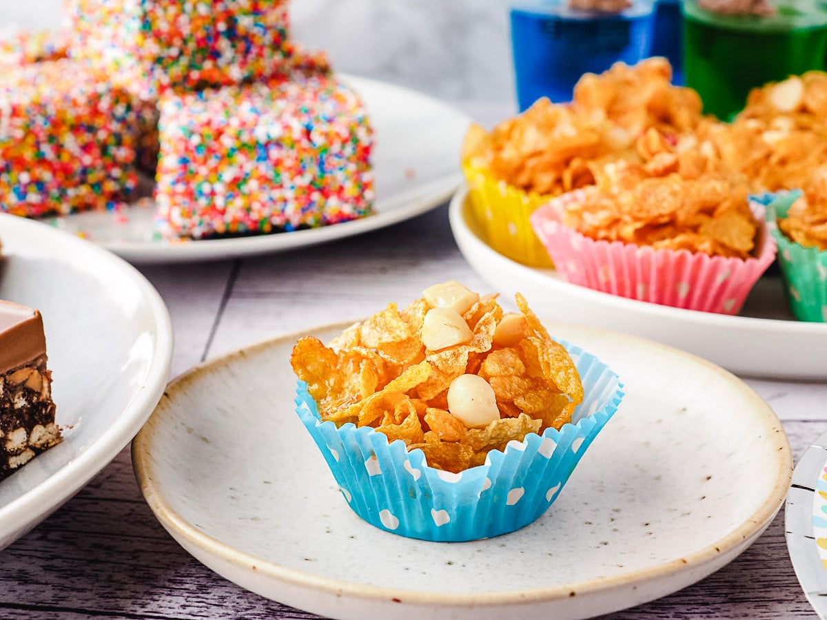 Honey Joys 1 Honey joy on a plate with party food in background.