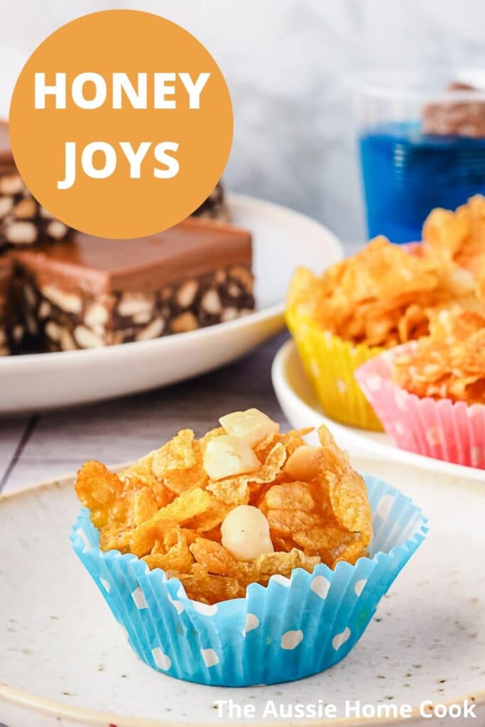 Honey Joys 11 Honey joy on a plate with party food in the background.