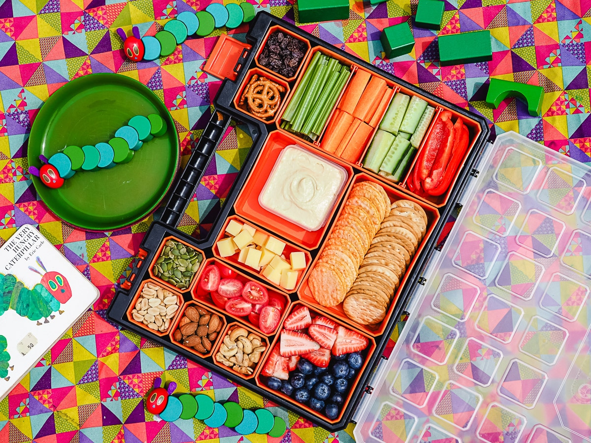 Kids Charcuterie Board 1 Charcuterie board on a picnic blanket with kids toys.