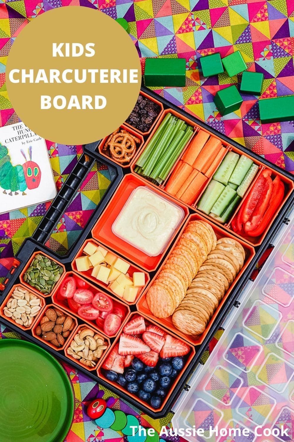 Kids Charcuterie Board 8 Charcuterie board on a picnic blanket with kids toys.