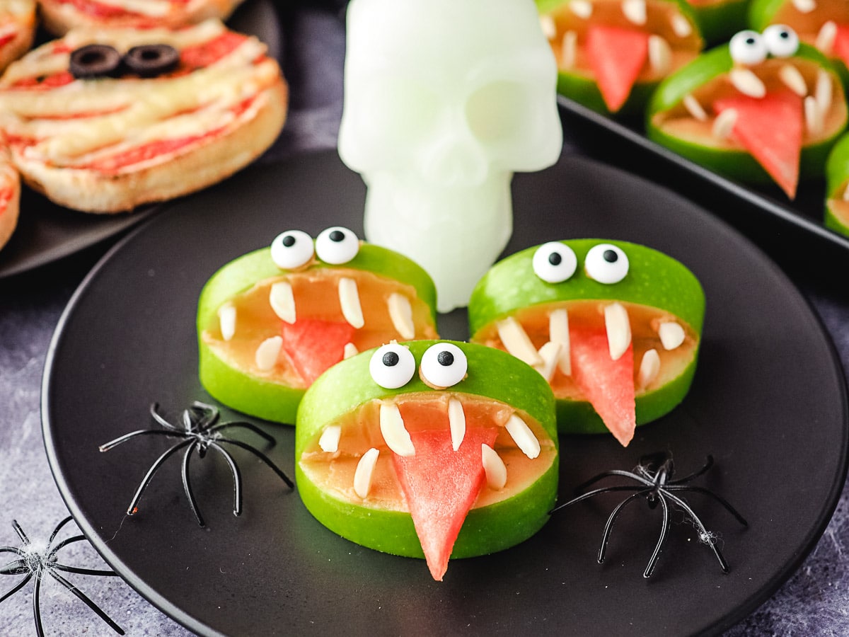 Apple Monsters 6 Halloween apple monsters on a plate with toy skull and spiders.