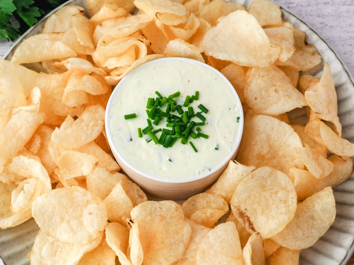 Sour Cream Dip 7 Sour cream dip on a serving plate surrounded by chips.