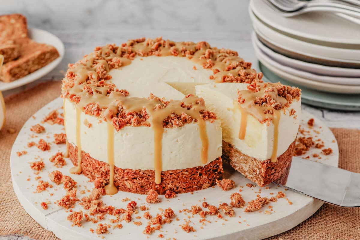 Anzac Cheesecake 1 Taking a slice of Anzac cheesecake drizzled with golden syrup caramel.