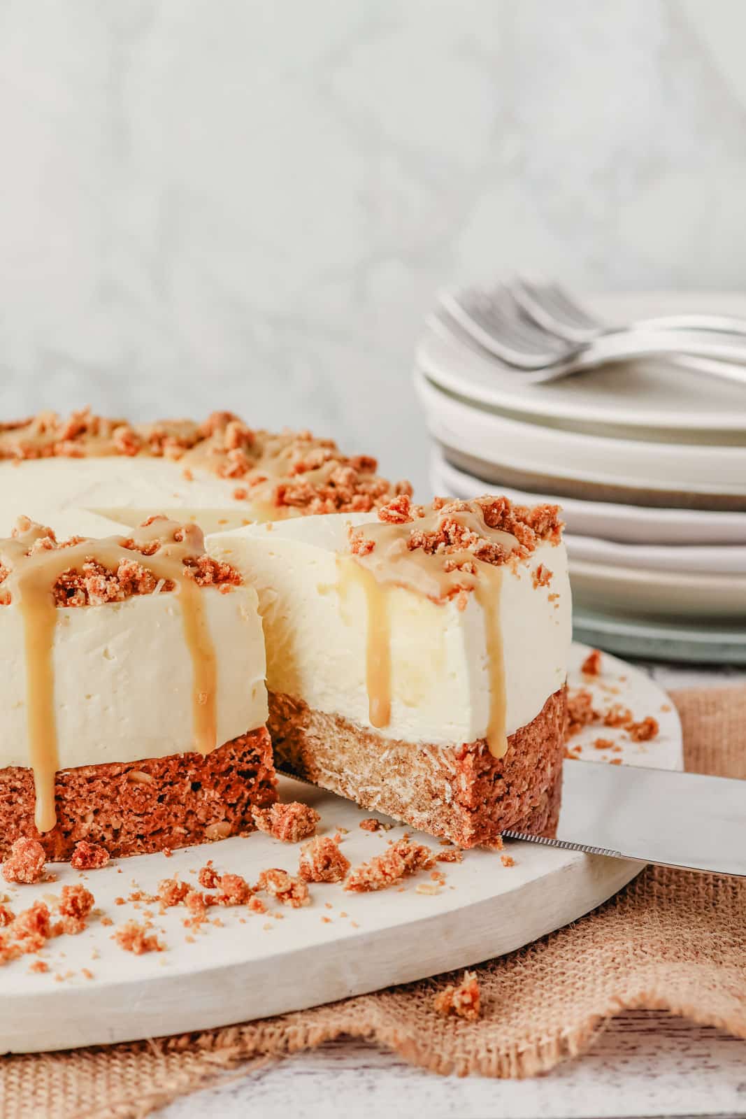 Anzac Cheesecake 12 Taking a slice of Anzac cheesecake drizzled with golden syrup caramel.